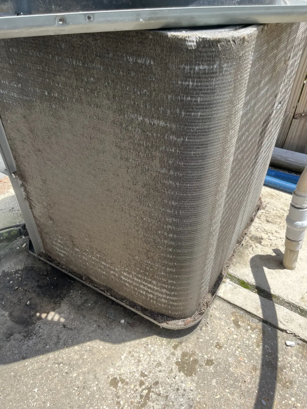Outdoor condenser coil coated with dirt, Metairie