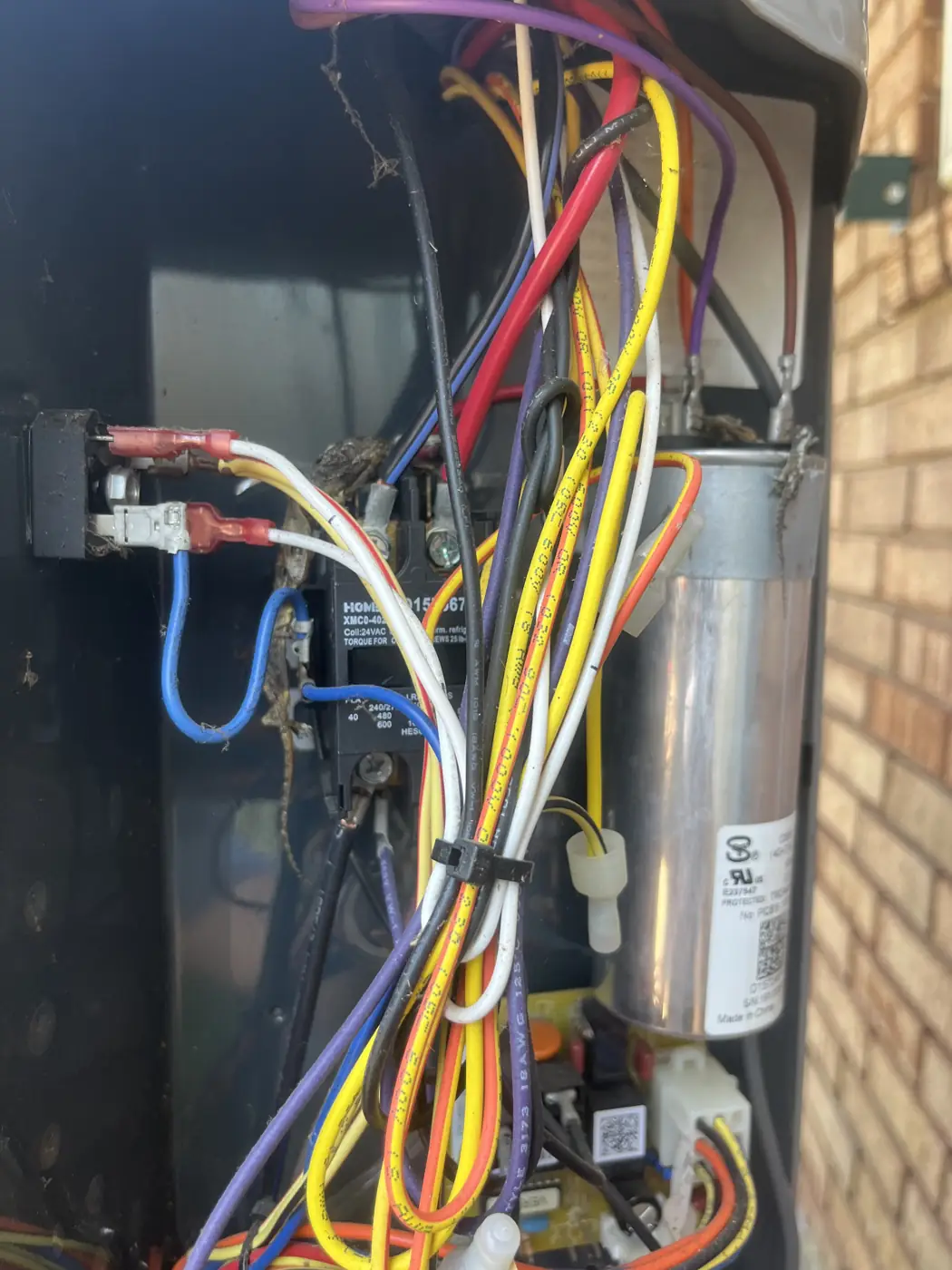 Open AC control panel showing wiring and a run capacitor, Kenner